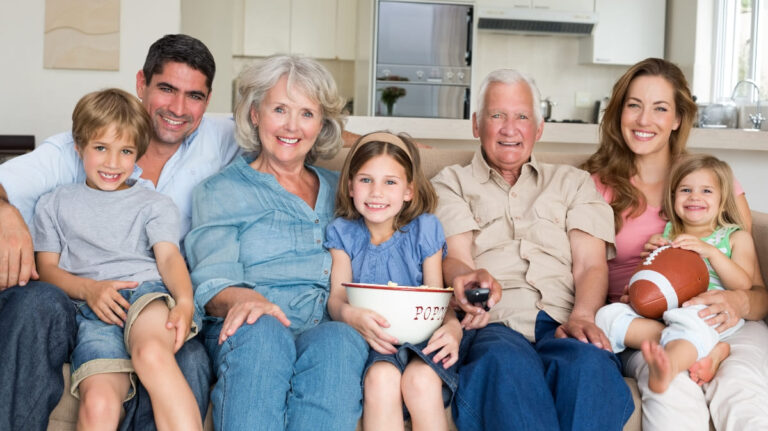 Medium shot family portrait indoors representing Super Visa insurace.